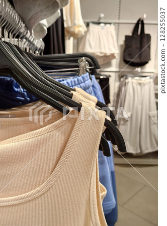 clothing display featuring tank tops and activewear in retail store setting. closeup. 128255037