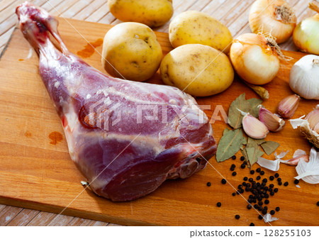 Raw lamb leg with natural ingredients before cooking Raw lamb leg with natural ingredients before cooking 128255103