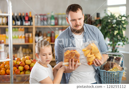 Man with son holding plastic containers with poultry parts, choose chicken meat. Man with son holding plastic containers with poultry parts, choose chicken meat. 128255112