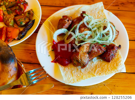 Barbecued pork shashlik with onion and herbs 128255206