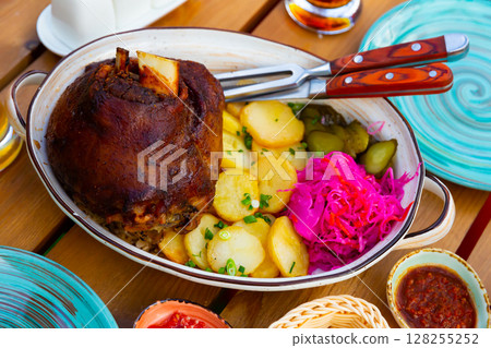German pork hock with sliced potato and marinaded foods 128255252