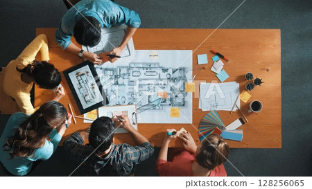 Top view of smart engineer looking at blueprint at meeting room. Symposium. Top view of smart engineer looking at blueprint at meeting room. Symposium. 128256065