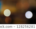Abstract bokeh background featuring soft glowing orange and white lights on dark Abstract bokeh background featuring soft glowing orange and white lights on dark 128256281