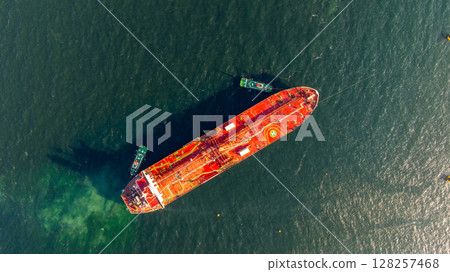 Aerial view oil ship tanker vessel loading and unloading in oil terminal station refinery, Global business import export logistic transport sea freight cargo tanker, Red crude oil tanker ship at port. 128257468