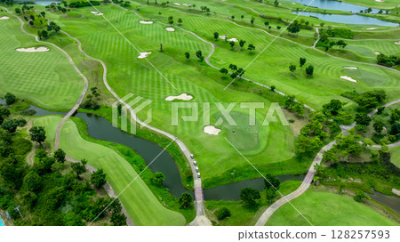 Aerial top view golf course with lush greens, green fairway and sand bunker, Golf course green grass and trees fairway and putting green, Beautiful golf course. 128257593