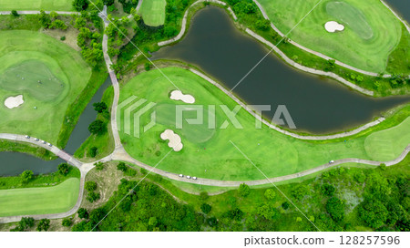 Aerial top view golf course with lush greens, green fairway and sand bunker, Golf course green grass and trees fairway and putting green, Beautiful golf course. 128257596