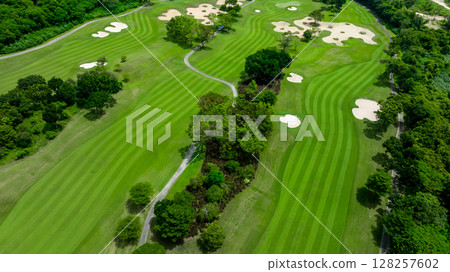 Aerial top view golf course with lush greens, green fairway and sand bunker, Golf course green grass and trees fairway and putting green, Beautiful golf course. 128257602