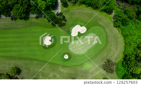 Aerial top view golf course with lush greens, green fairway and sand bunker, Golf course green grass and trees fairway and putting green, Beautiful golf course. Aerial top view golf course with lush greens, green fairway and sand bunker, Golf course green grass and trees fairway and putting green, Beautiful golf course. 128257603