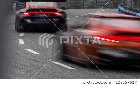 Motion blur race car racing on speed track, Motion blurred super car race on street track circuit, Automobile automotive transportation vehicle background, 128257627
