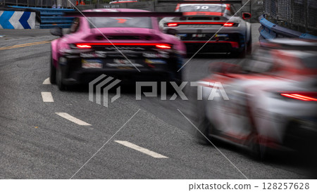 Motion blur race car racing on speed track, Motion blurred super car race on street track circuit, Automobile automotive transportation vehicle background, 128257628