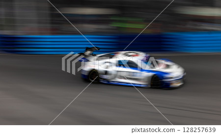 Motion blur race car racing on speed track, Motion blurred super car race on street track circuit, Automobile automotive transportation vehicle background, Motion blur race car racing on speed track, Motion blurred super car race on street track circuit, Automobile automotive transportation vehicle background, 128257639