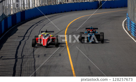 Motion blur race car racing on speed track, Motion blurred super car race on street track circuit, Automobile automotive transportation vehicle background, Race car drive on street track. 128257673