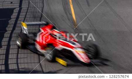 Motion blur race car racing on speed track, Motion blurred super car race on street track circuit, Automobile automotive transportation vehicle background, Race car drive on street track. 128257674