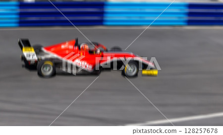 Motion blur race car racing on speed track, Motion blurred super car race on street track circuit, Automobile automotive transportation vehicle background, Race car drive on street track. Motion blur race car racing on speed track, Motion blurred super car race on street track circuit, Automobile automotive transportation vehicle background, Race car drive on street track. 128257678