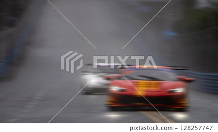 Motion blur race car racing on speed track, Motion blurred super car race on street track circuit, Automobile automotive transportation vehicle background. 128257747