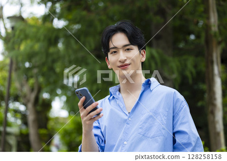 A young man with a smartphone 128258158