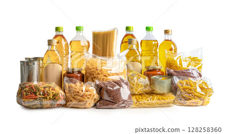 Foodstuff for donation, storage and delivery. Various food, pasta, cooking oil and canned food in cardboard box. 128258360