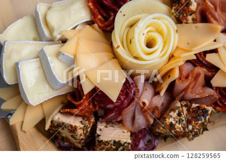 Cheese and meat charcuterie board. Gift present idea, dinner lunch plate. Minimal effort visually pleasing snacks. Simple meal preparation with special cheese knives 128259565