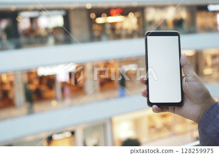 Capturing a moment with a smartphone in a shopping mall Capturing a moment with a smartphone in a shopping mall 128259975