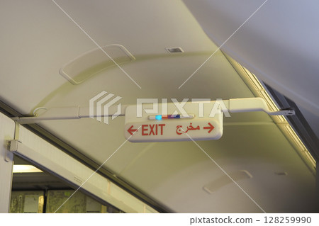 Sign indicating exit on an aircraft during flight Sign indicating exit on an aircraft during flight 128259990
