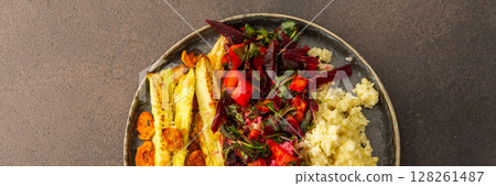 Delight in a flavorful vegetarian lunch or breakfast with millet, roasted zucchini and carrots, a fresh salad with seasonal vegetables and herbs, banner 128261487