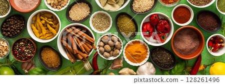 A colorful assortment of fresh, fragrant spices and herbs displayed on a soft green background, capturing a vibrant culinary essence, banner A colorful assortment of fresh, fragrant spices and herbs displayed on a soft green background, capturing a vibrant culinary essence, banner 128261496
