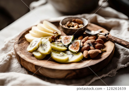 Delicious breakfast boards featuring fresh fruit and nuts arranged on a wooden platter for a healthy morning meal 128261639