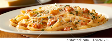 A bowl of traditional Italian pasta awaits on a wooden dining table. It features light cream sauce, herbs, and grated cheese, inviting a genuine culinary experience in Italy, banner A bowl of traditional Italian pasta awaits on a wooden dining table. It features light cream sauce, herbs, and grated cheese, inviting a genuine culinary experience in Italy, banner 128261780