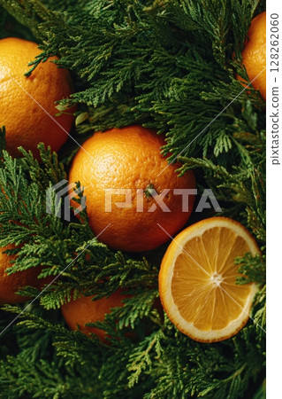 Fresh Oranges and Green Leaves on a Rustic Wooden Surface 128262060
