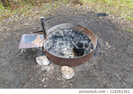 A steel ringed fire pit in a large family campground in the mountains A steel ringed fire pit in a large family campground in the mountains 128262262