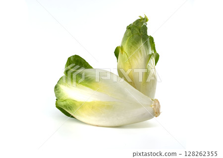 Two heads of fresh Belgian endive isolated on a white background, ready to eat or cook. Two heads of fresh Belgian endive isolated on a white background, ready to eat or cook. 128262355