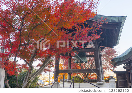 Autumn in Kyoto: Honganji Kitayama Betsuin Temple's mountain gate and bell tower surrounded by autumn leaves 128262560
