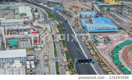 July 6 2025 Modern Road Construction Site with Heavy Machinery and Infrastructure Development 128263086