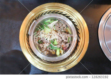 Sukiyaki ,suki or shabu pot and sliced beef or vegetable soup in the pot Sukiyaki ,suki or shabu pot and sliced beef or vegetable soup in the pot 128263192