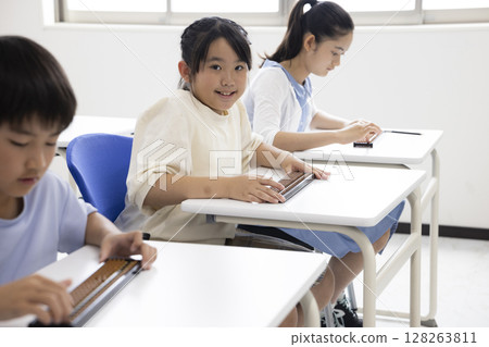 Elementary school student using abacus 128263811