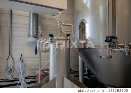 Modern stainless steel brewing equipment in craft brewery for beer production Modern stainless steel brewing equipment in craft brewery for beer production 128263896