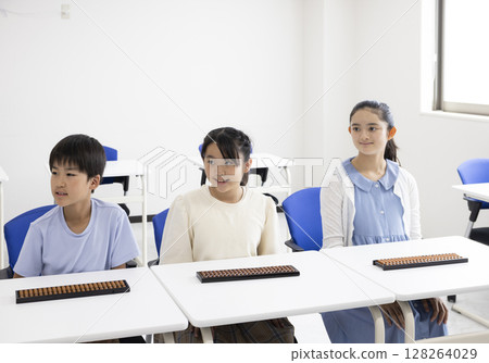 Elementary school student using abacus 128264029