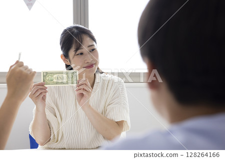 Elementary school students learning about money 128264166