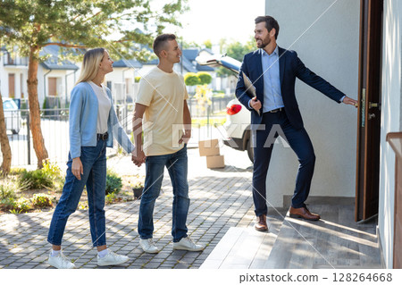 Male real estate agent presenting a new house to the clients Male real estate agent presenting a new house to the clients 128264668