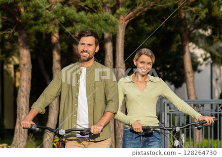 Man and woman with bikes outside home ready for outdoor ride Man and woman with bikes outside home ready for outdoor ride 128264730
