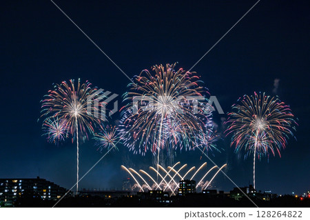 A large flower of light blooming in the night sky 128264822