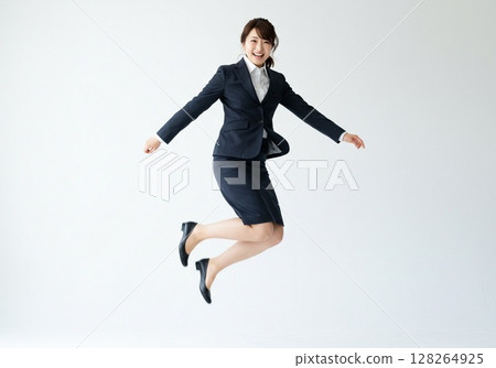 Japanese OL pose / Jumping with a smile (white background, for cutting) 128264925