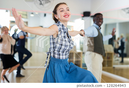 Man and woman performing jazz dance in dancing room 128264943
