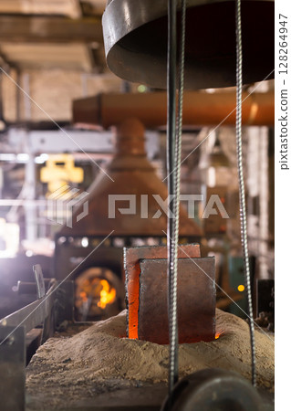 Ferrous metal billet is melted in an induction furnace closeup Ferrous metal billet is melted in an induction furnace closeup 128264947