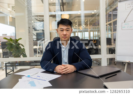 Asian young businessman working in his office and looking busy 128265310