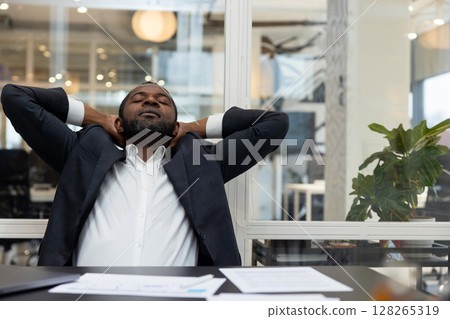 African american businessman feeling relaxed after a long busy working day 128265319