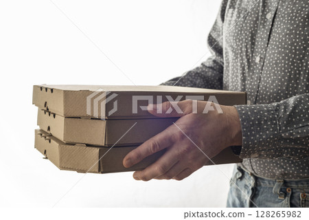 Caucasian male hands hold three pizza boxes side view with copy-space 128265982