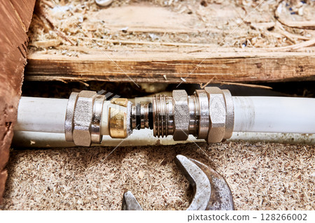 Compression coupling is positioned with insert facing inside multilayer pipe where compression ring is placed at end before nut is tightened to secure connection. 128266002