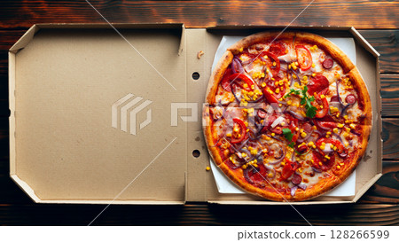 Pepperoni pizza with bell peppers sweetcorn and arugula in open carton box on dark wooden table flat lay with copy-space Pepperoni pizza with bell peppers sweetcorn and arugula in open carton box on dark wooden table flat lay with copy-space 128266599