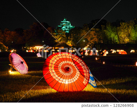 Illuminated Japanese umbrellas and Okayama Castle tower 128266908